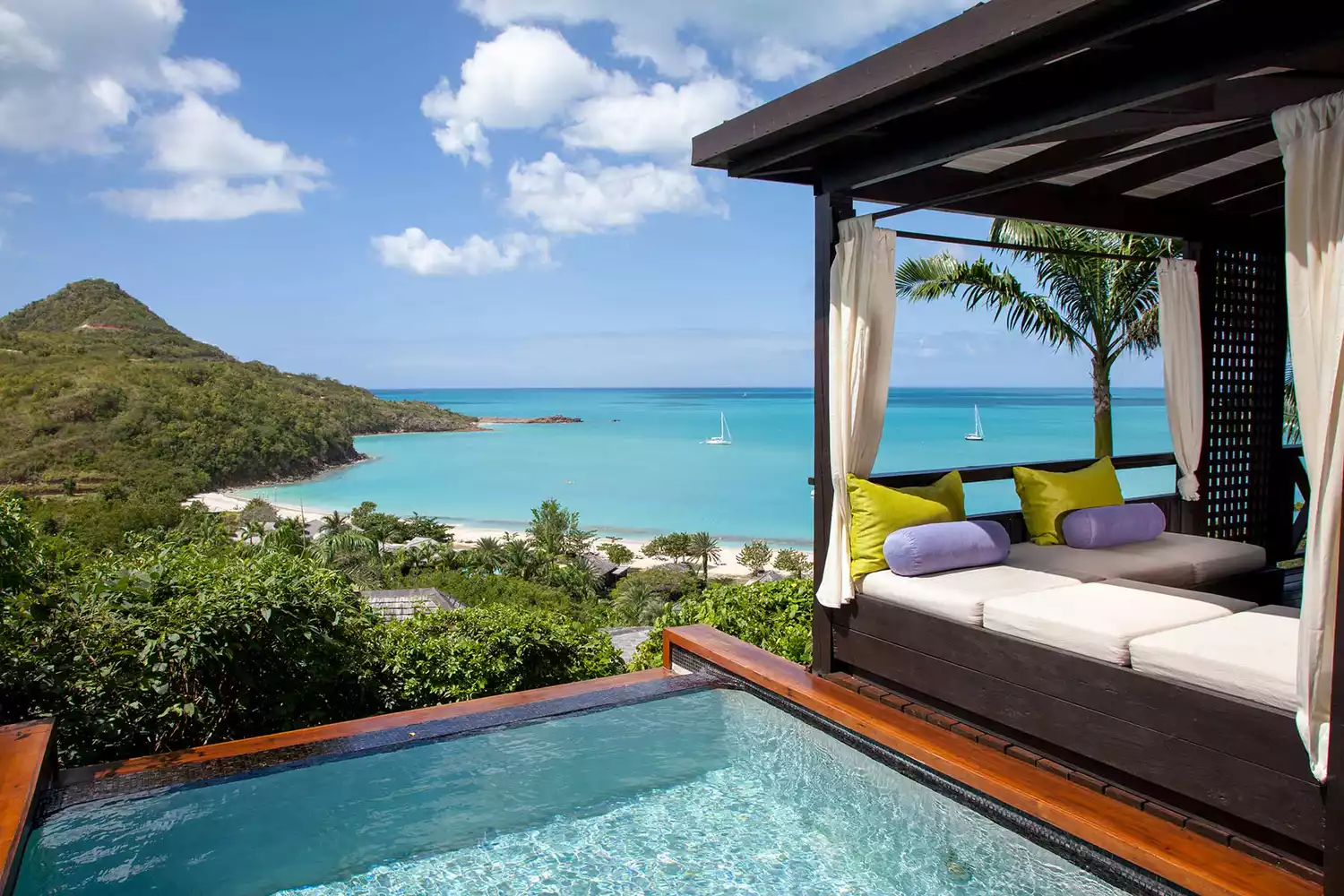 Hillside Pool Suite at Hermitage Bay overlooking the Caribbean sea and lush greenery.