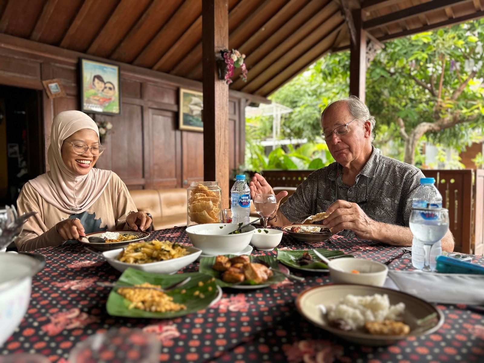 A variety of local Javanese dishes served on a table for a family meal.