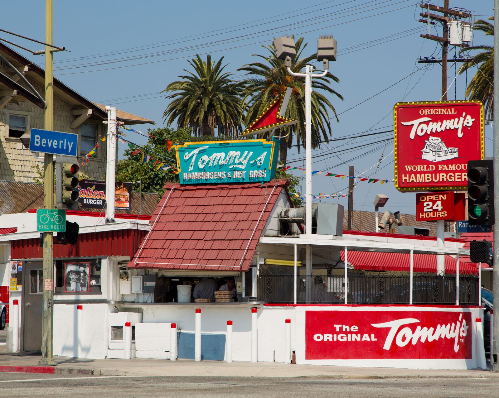 Sun-drenched Los Angeles street view featuring iconic palm trees and city architecture.