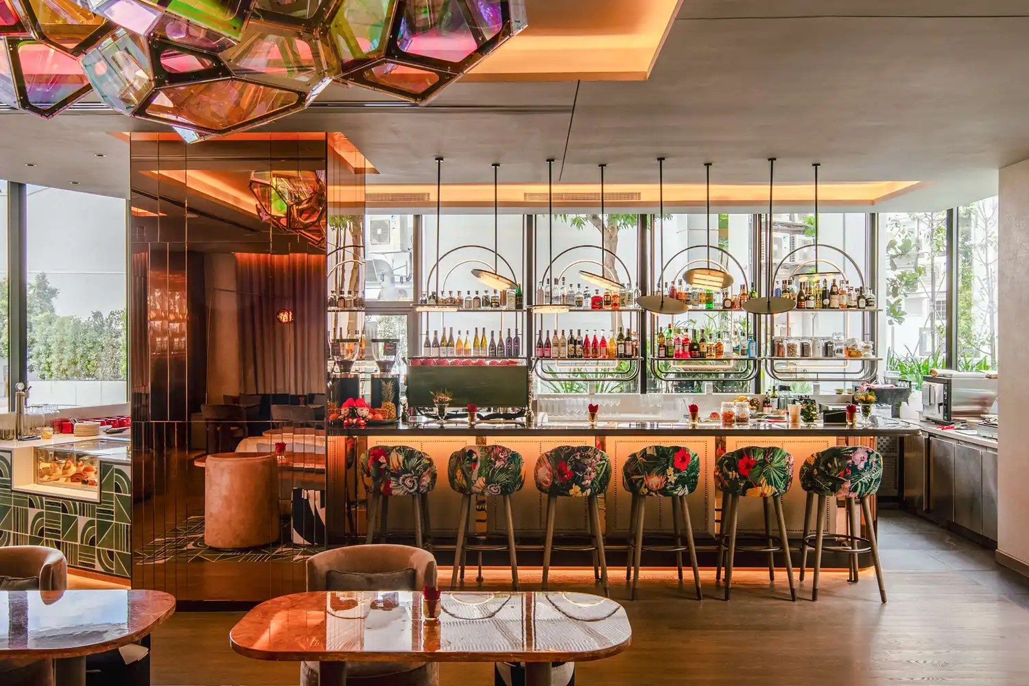 Christina's dining room at Mondrian Singapore Duxton with high ceilings, decorative lighting, and floor-to-ceiling windows.