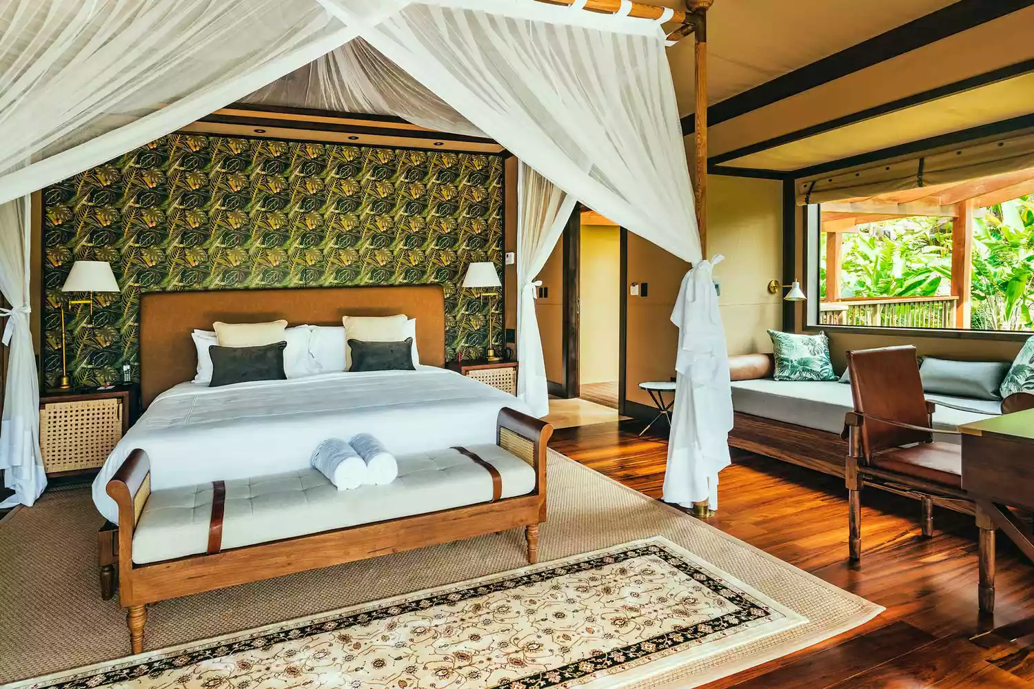 The interior of a luxury tented suite at Nayara Tented Camp overlooking the Arenal Volcano landscape.