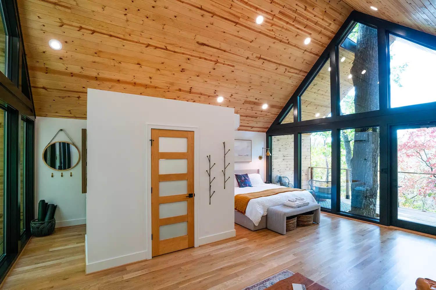 A modern and cozy bedroom and bathroom setup inside the Forestry House.