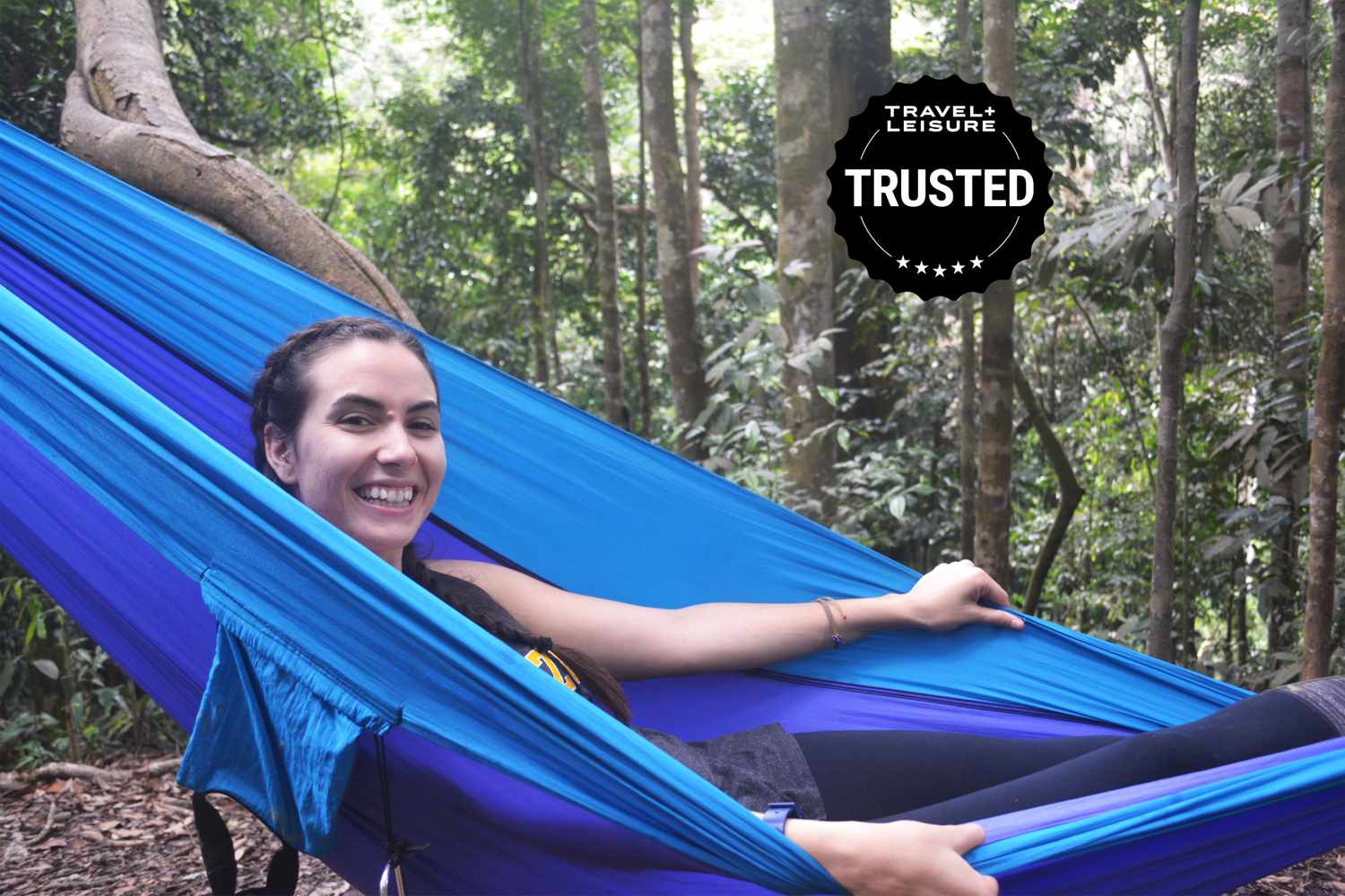 A lone camping hammock in the woods, highlighting its utility as a tent alternative.