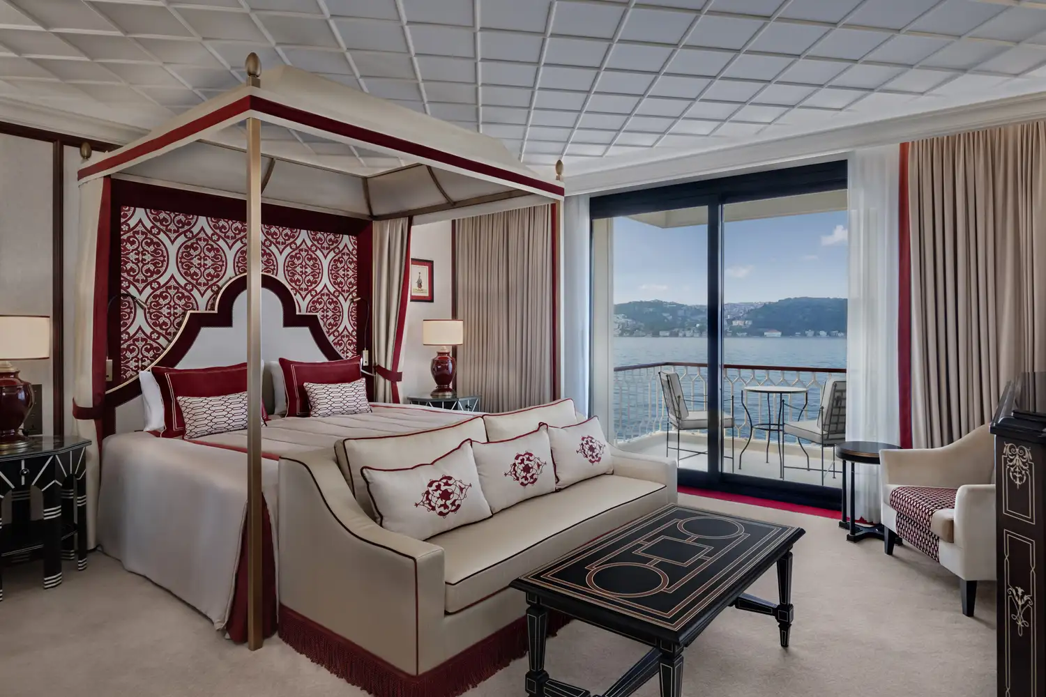 A luxury hotel suite with a canopy bed and a private balcony overlooking the Bosphorus.