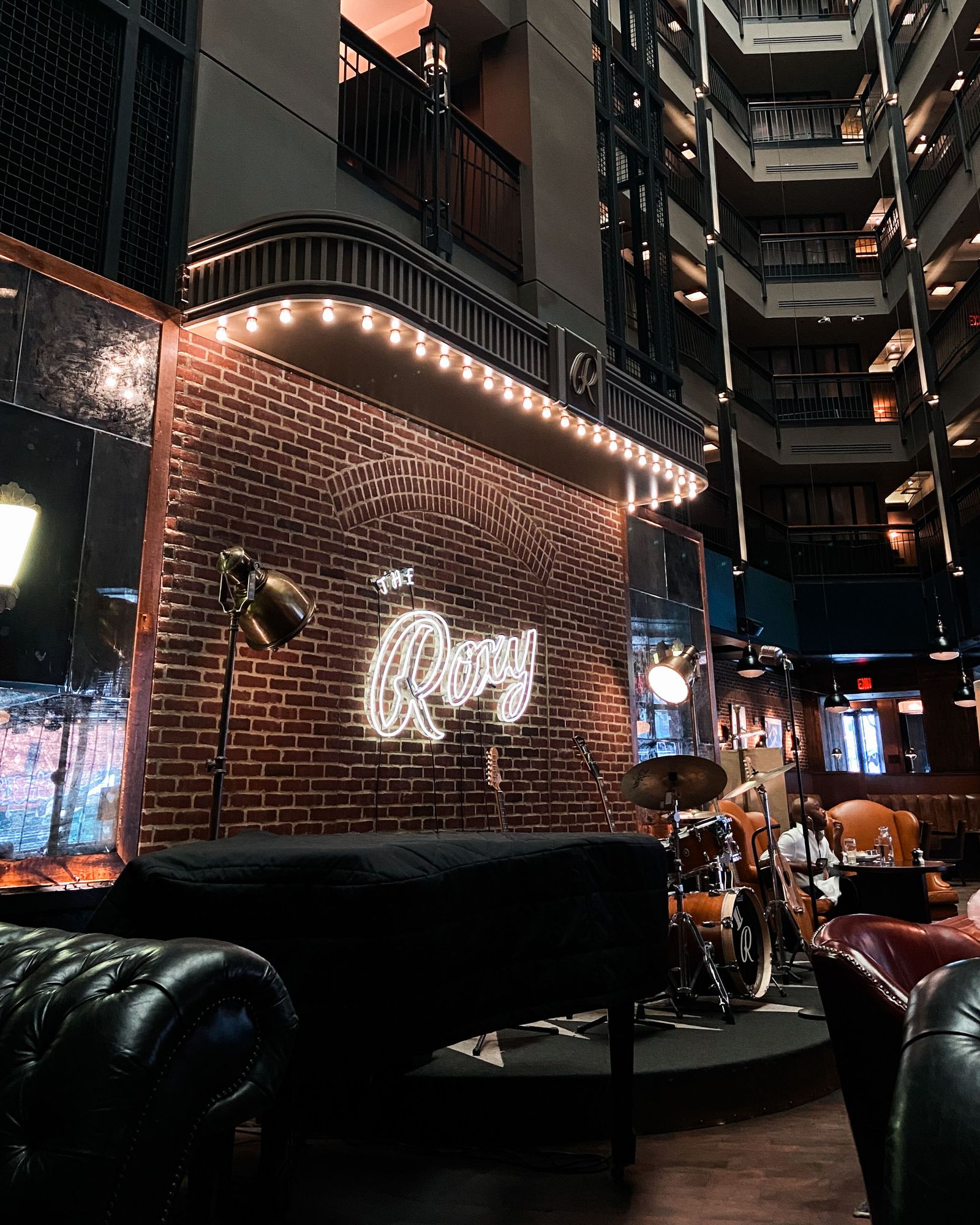 A bustling New York City street scene at night featuring neon lights and urban architecture.