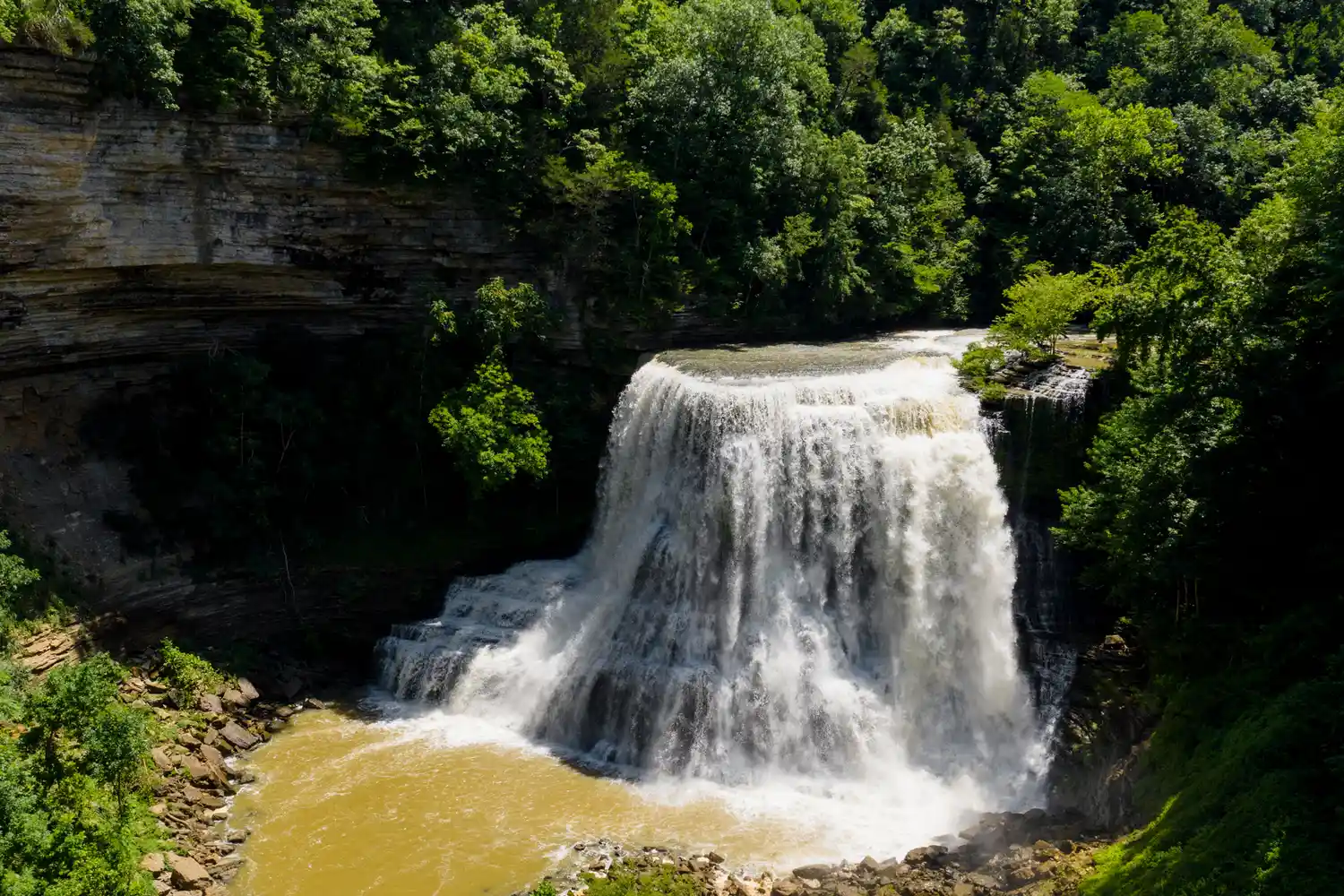 Burgess Falls dropping precipitously over a limestone ledge into a river below.