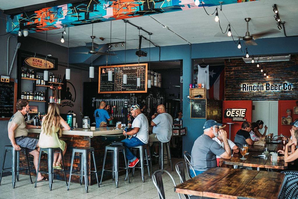 Casual brewery interior at Rincón Beer Company with local art and chalkboard beer menus.