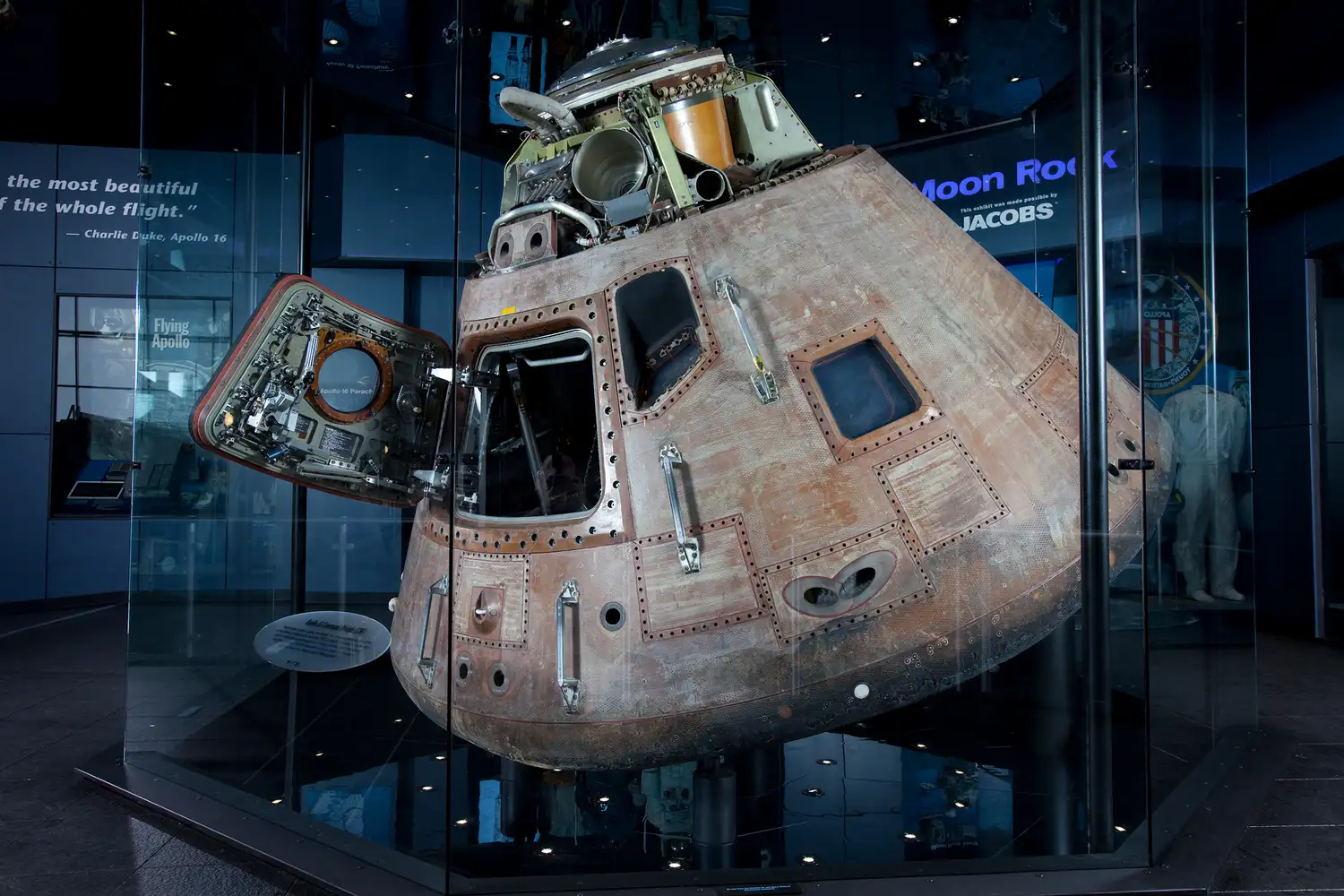 The Apollo 16 Command Module presented in a museum exhibit case.