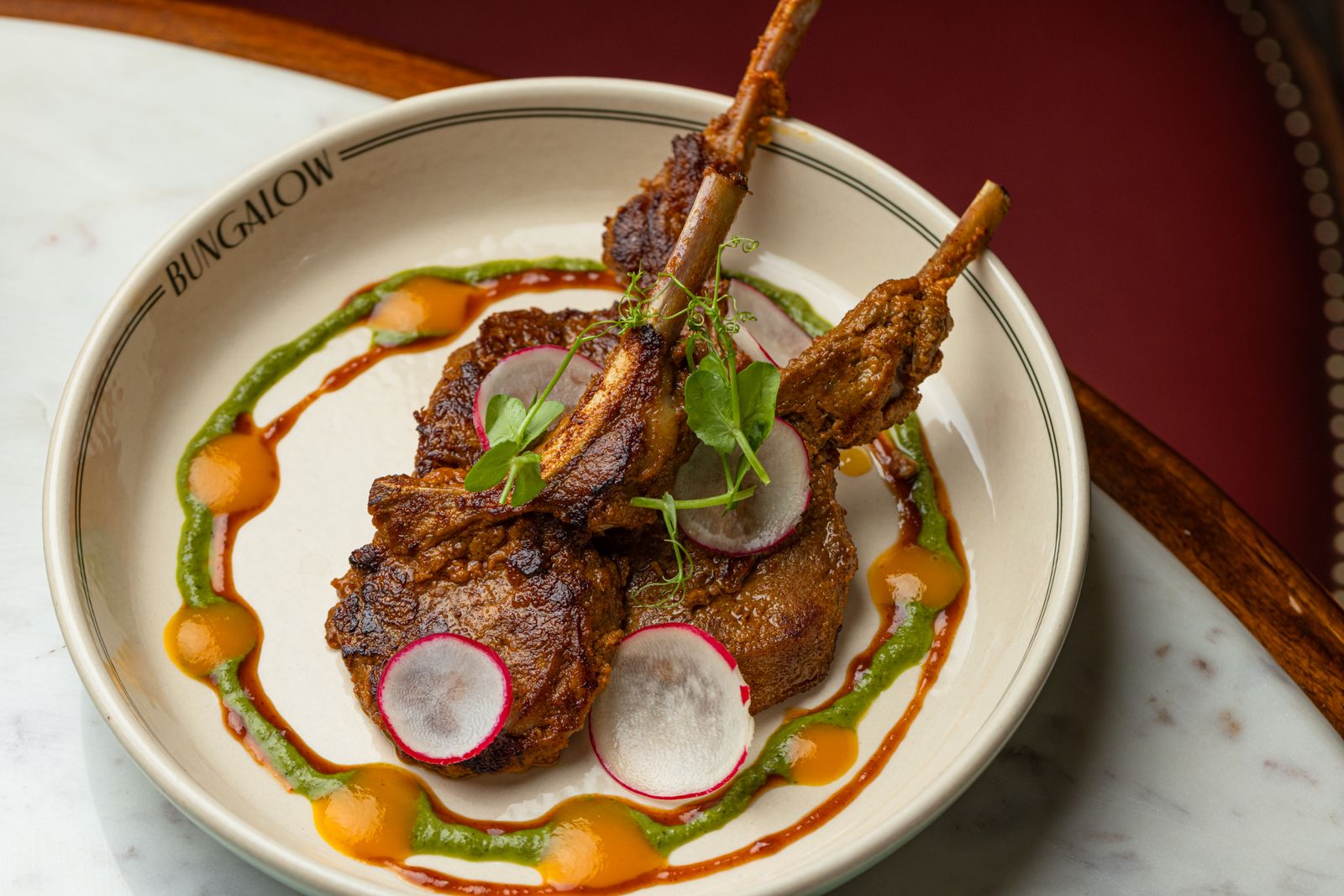 A masterfully plated Indian meat dish seasoned with regional spices.