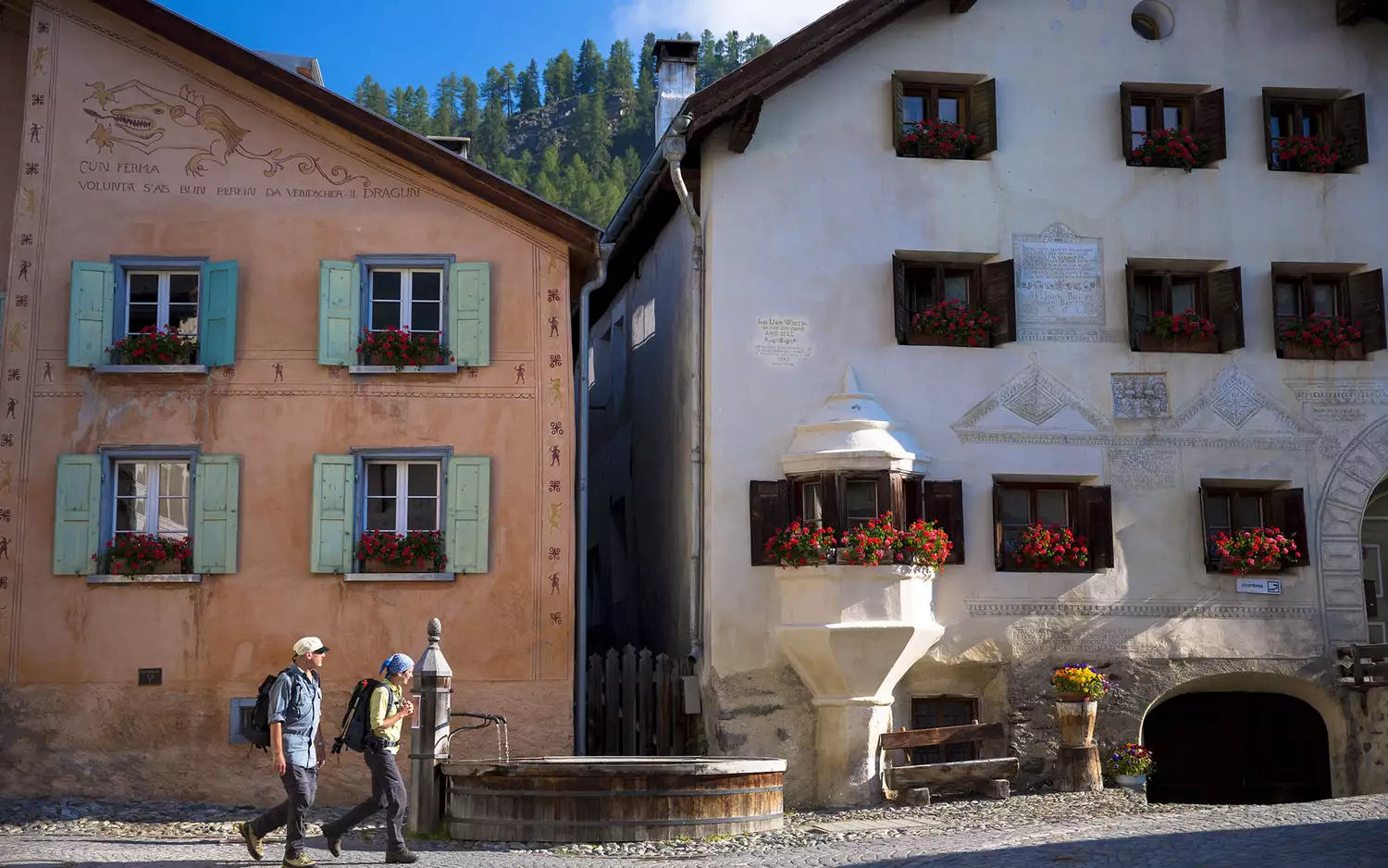 Traditional stone houses with decorative sgraffito art in the village of Guarda, Switzerland.