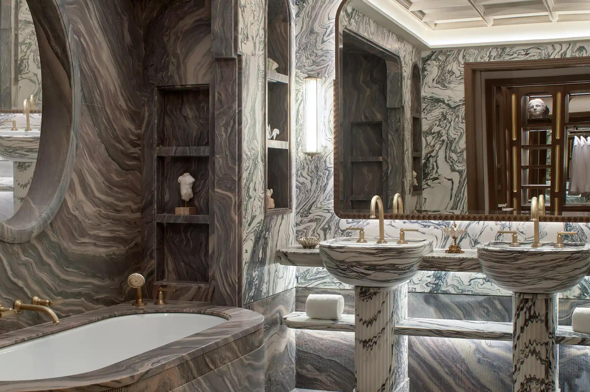 Luxurious marble bathroom with gold fixtures and a double vanity.