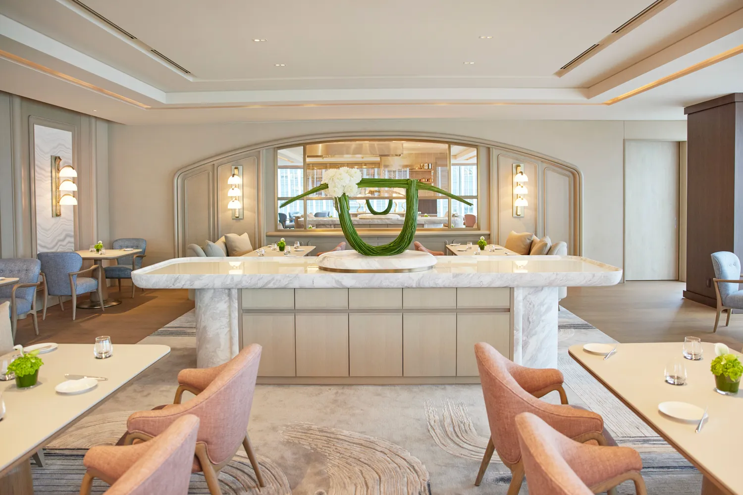 The elegant modern dining room at Sézanne restaurant with marble counters and minimalist décor.