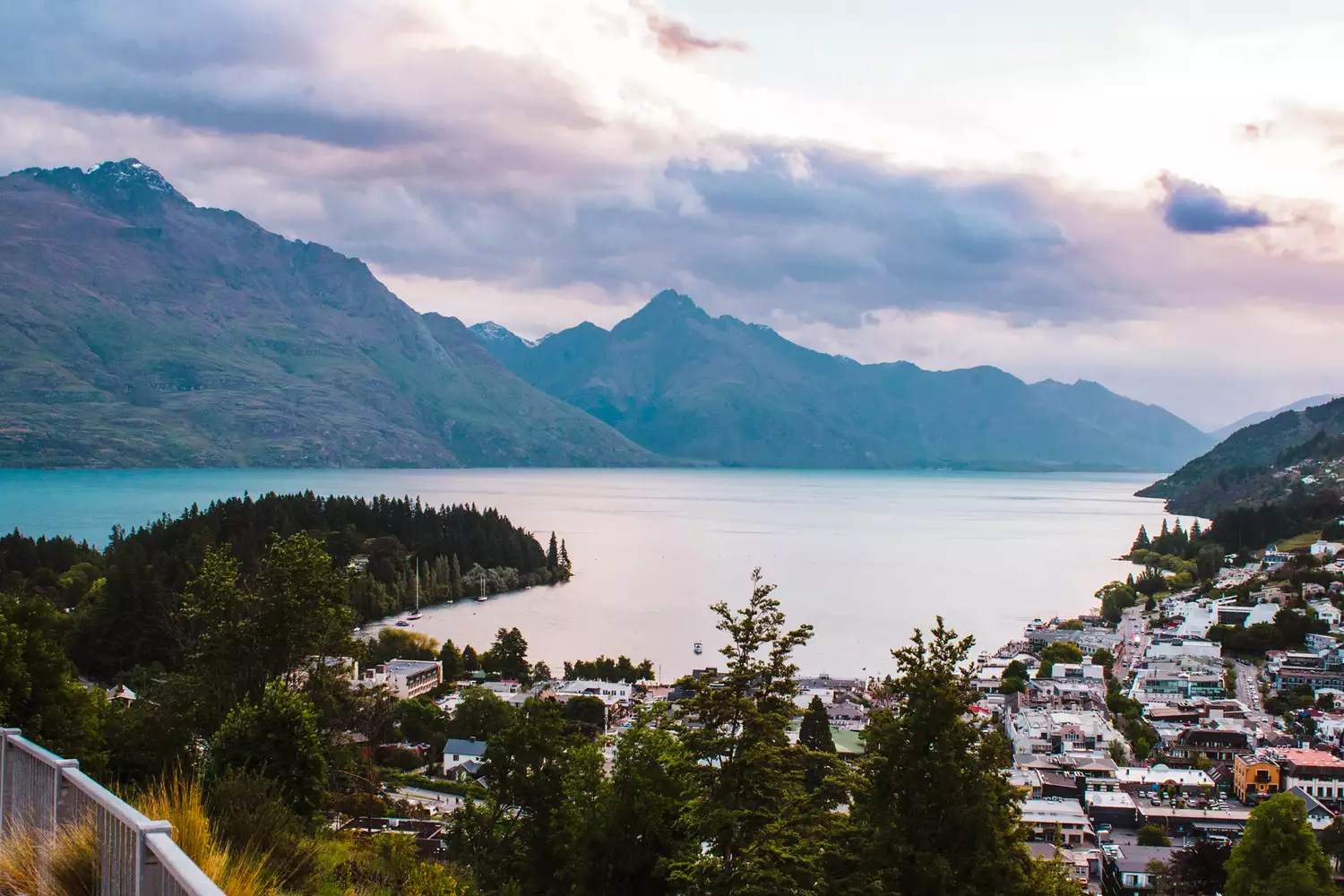 A twilight view of the Queenstown skyline nestled between mountains and Lake Wakatipu