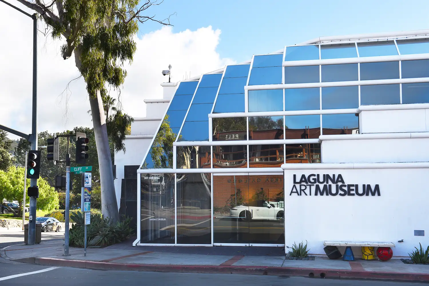 The modern grey architectural facade of the Laguna Art Museum under a clear sky.