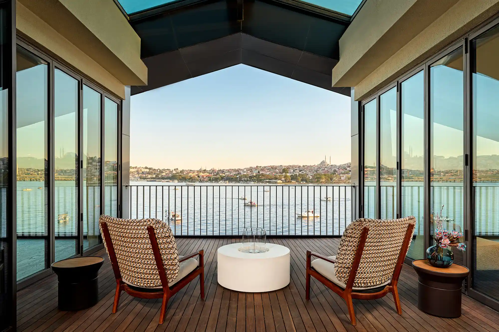 A private wooden deck with seating overlooking the Golden Horn waterfront and Istanbul skyline.