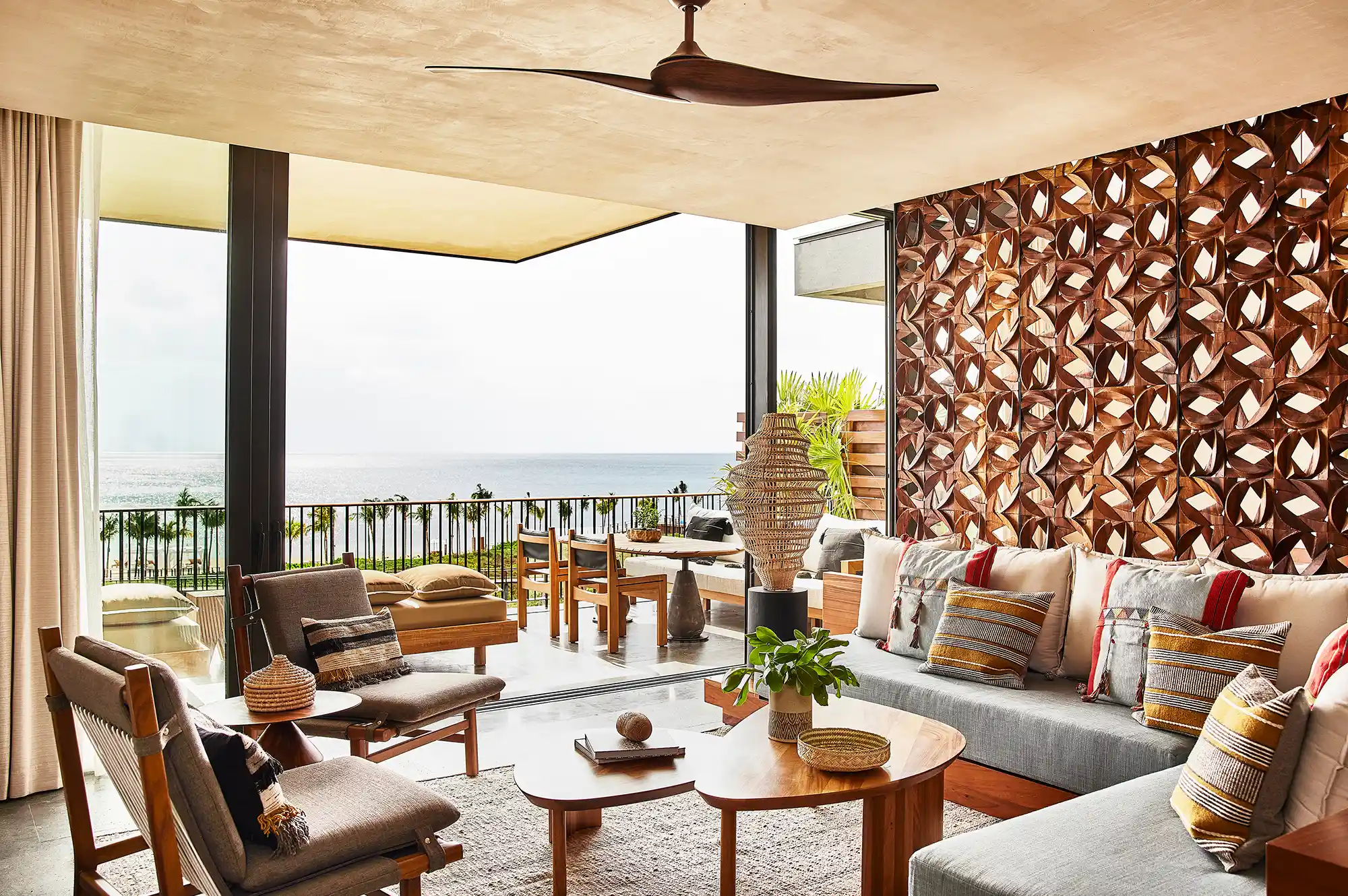 Modernist penthouse living room with floor-to-ceiling windows and intricate wooden screen accents.
