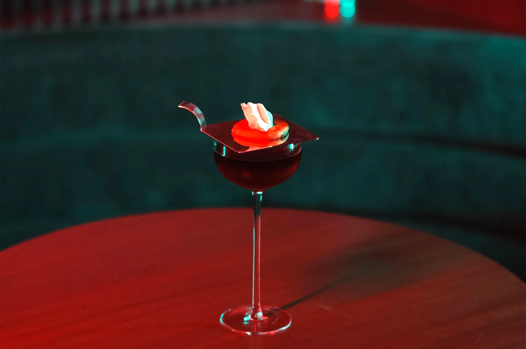 A close-up of a meticulously crafted cocktail at Night Hawk bar.