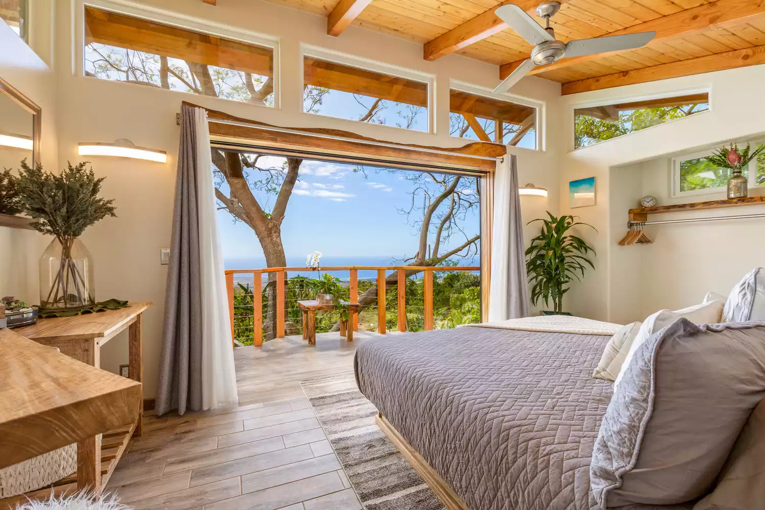A luxury multi-story treehouse elevated among the trees with modern architectural design.