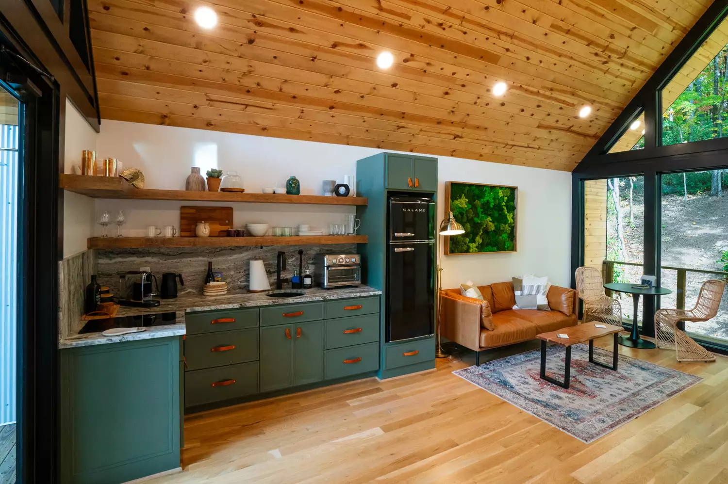 Interior view of the open-plan kitchen and living area inside the Forestry House treehouse.