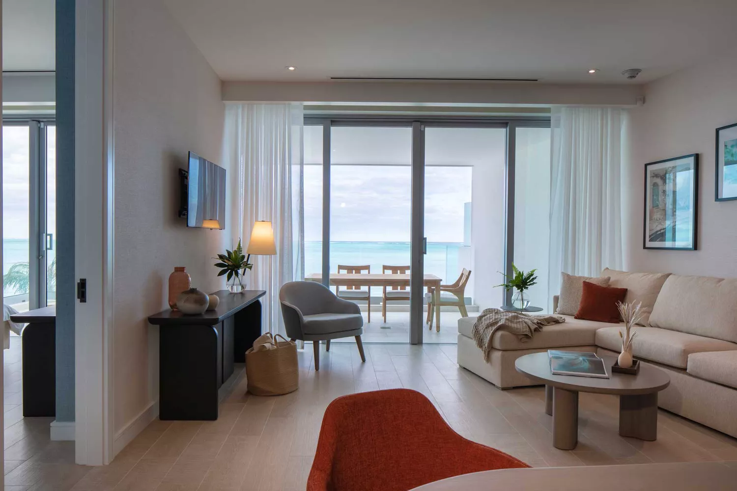 A spacious two-bedroom oceanfront suite living area with a private balcony at Goldwynn Resort.