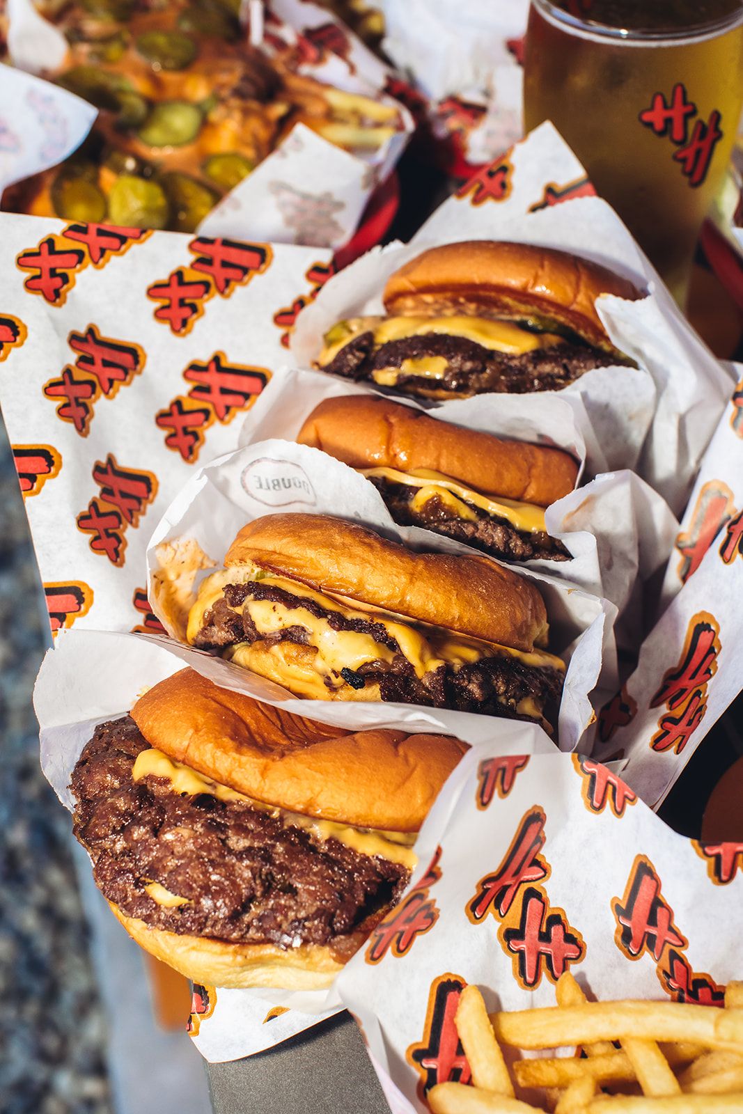 A gourmet burger paired with a cold beer in a high-end restaurant setting.