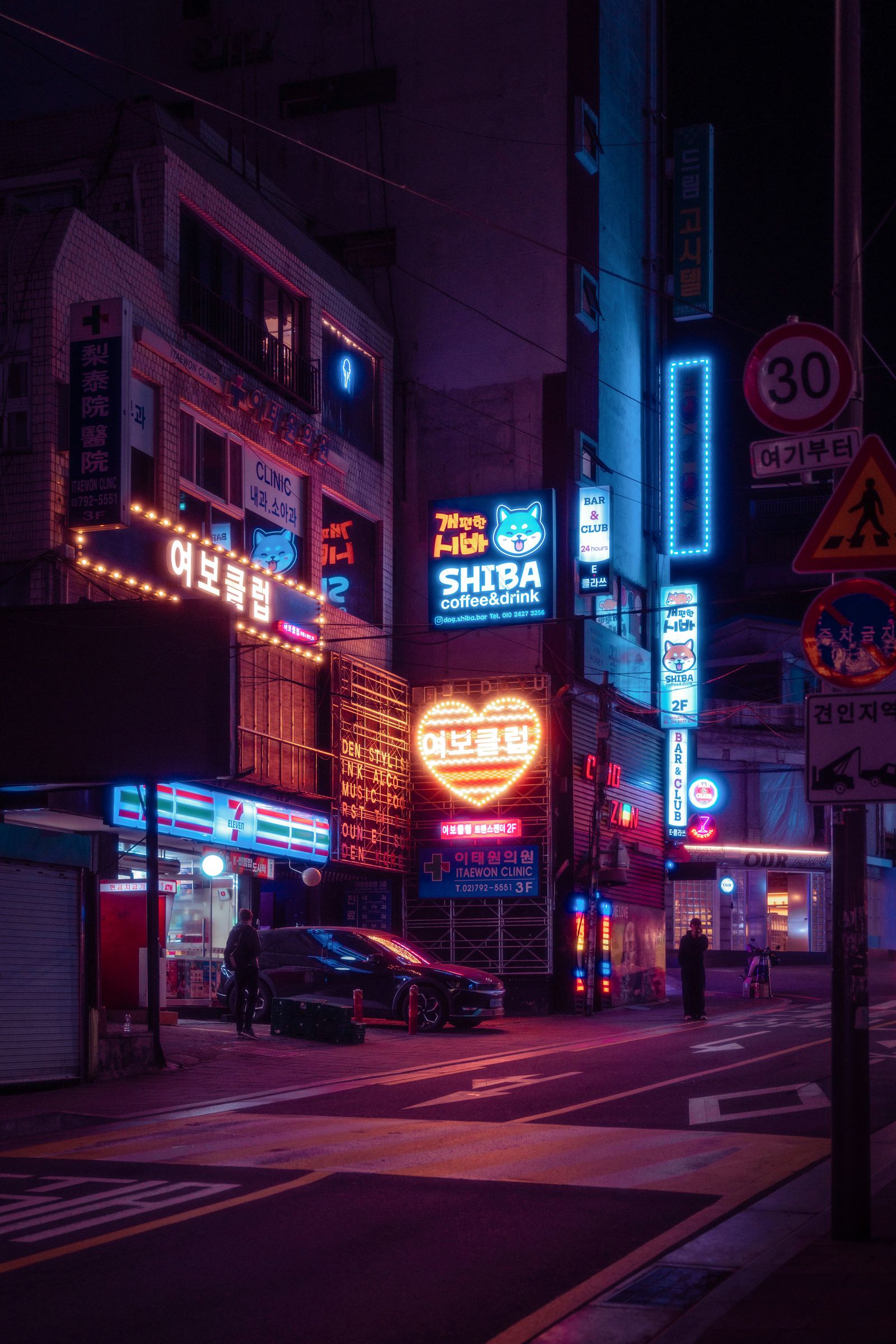 A busy Seoul city road at night with car lights and urban metropolis lighting.