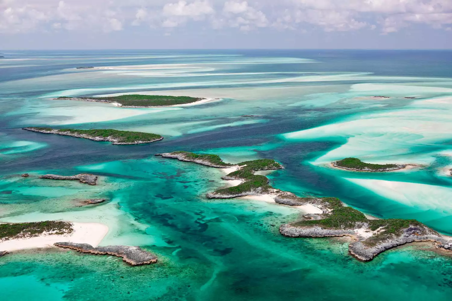Aerial view of the turquoise water and sandy cays of the Exumas, Bahamas.