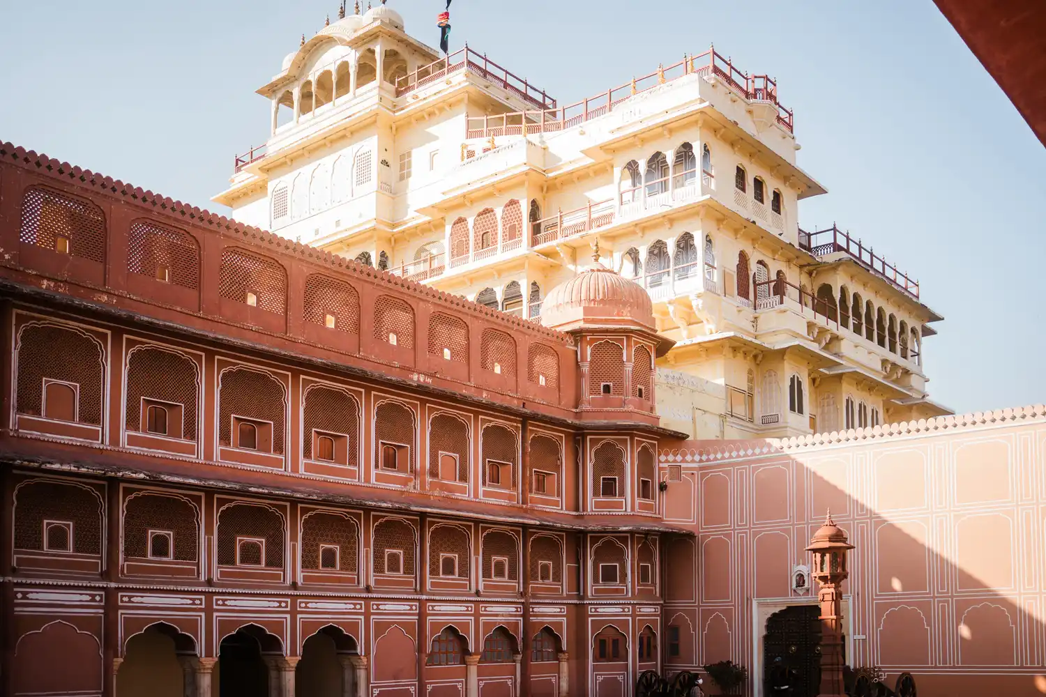 Detailed pink and white ornamental designs on the historic walls of the City Palace complex.