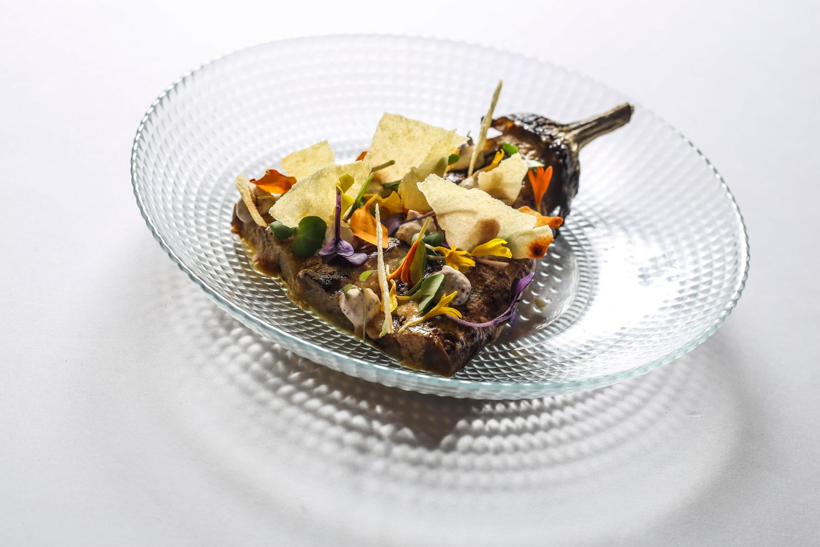 A meticulously plated meat dish representing fine dining standards in Mallorca.