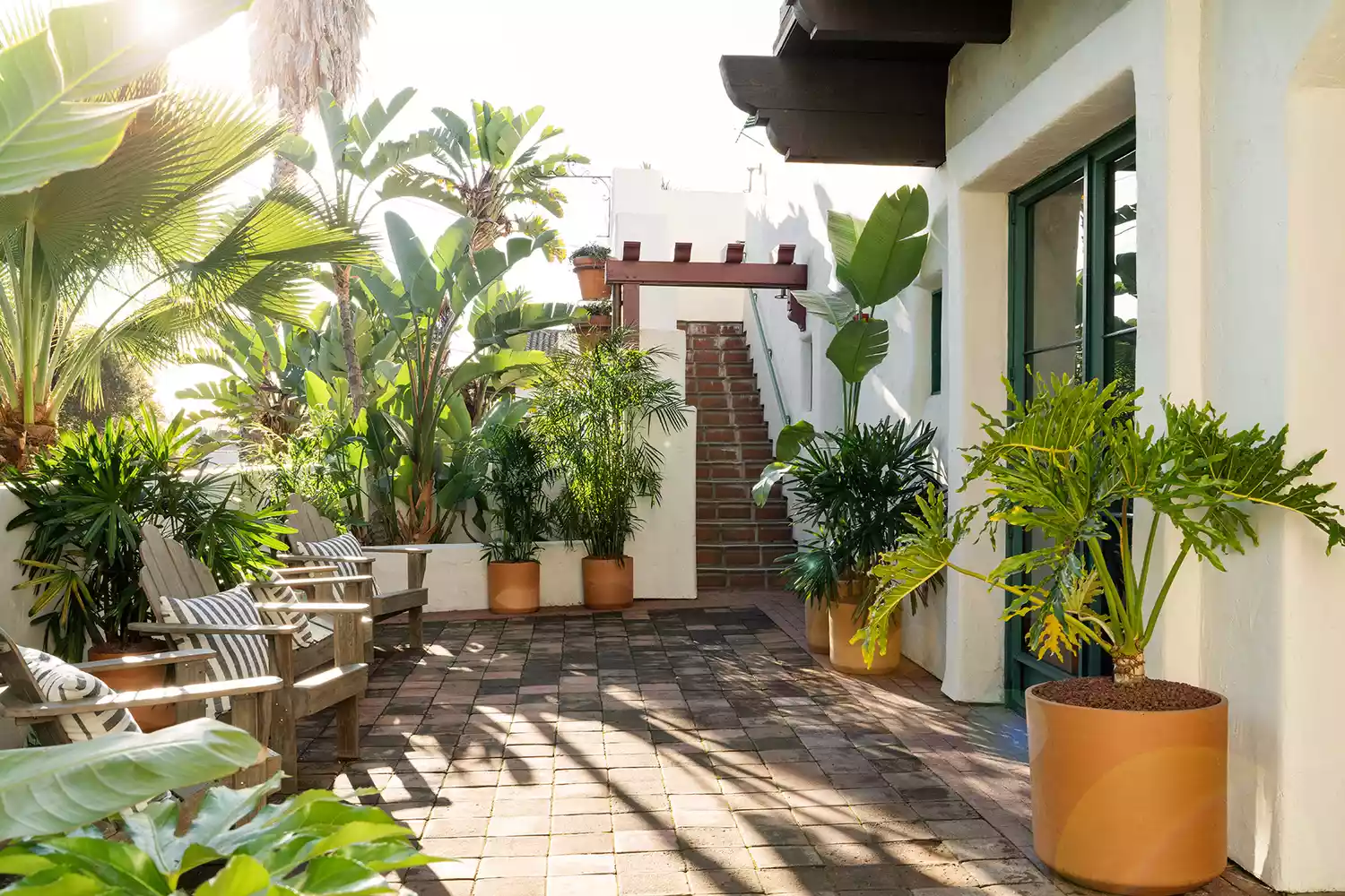 The central Mediterranean-style courtyard with lush greenery and patio seating.