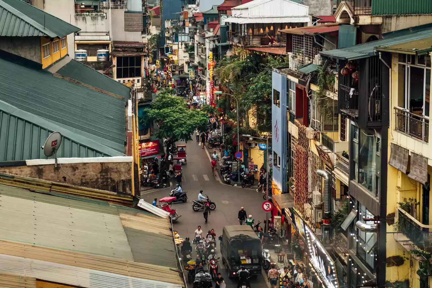 A busy city street in Hanoi view from above showing traffic and urban life.