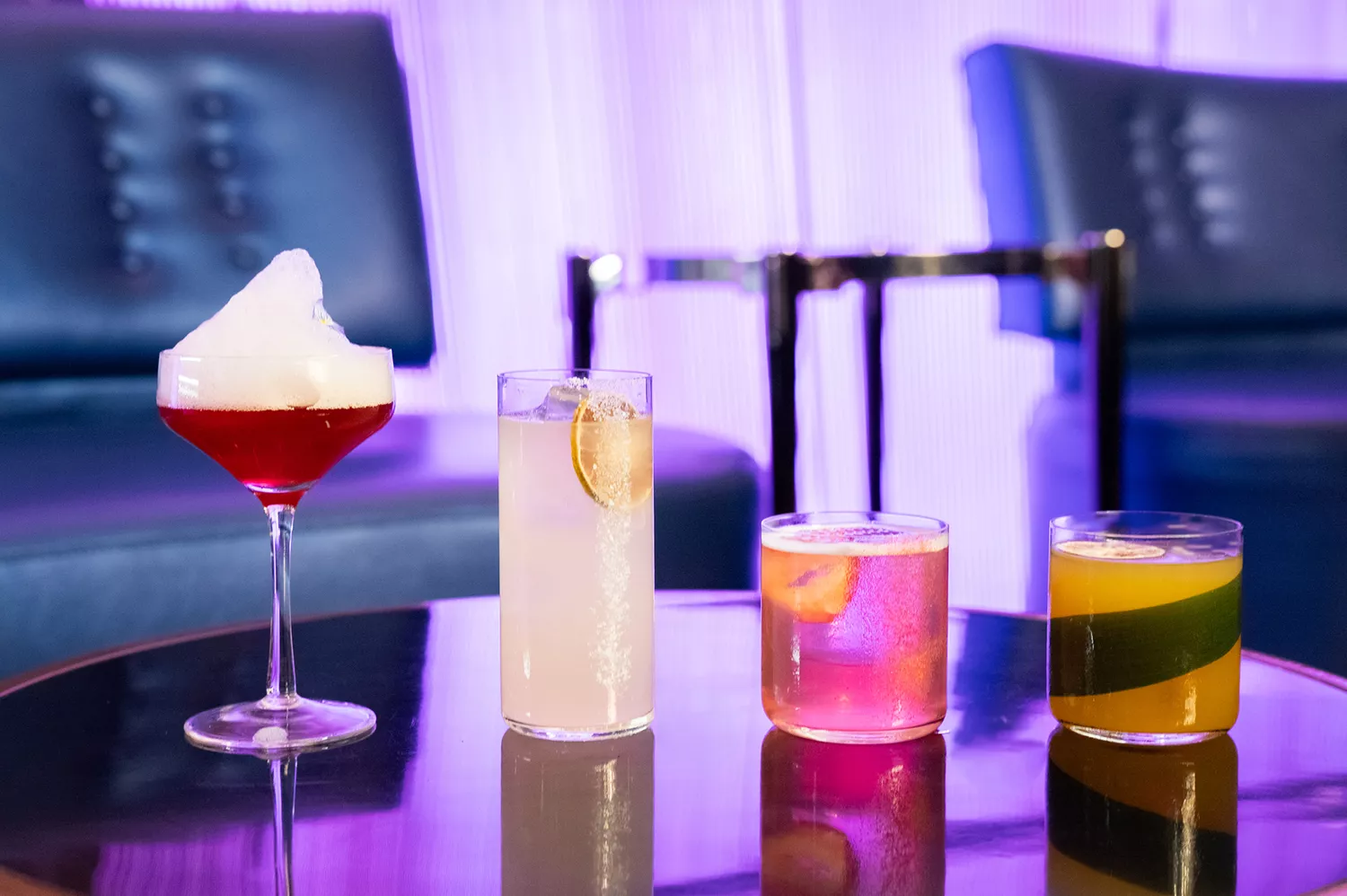 A flight of diverse cocktails featuring different colors and glassware at The Chandelier.