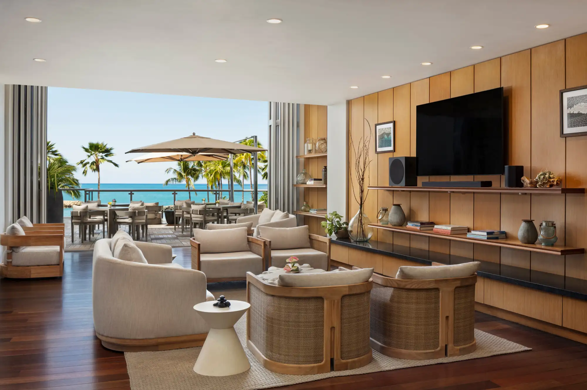 Luxurious suite living room with sea views and a large outdoor patio.