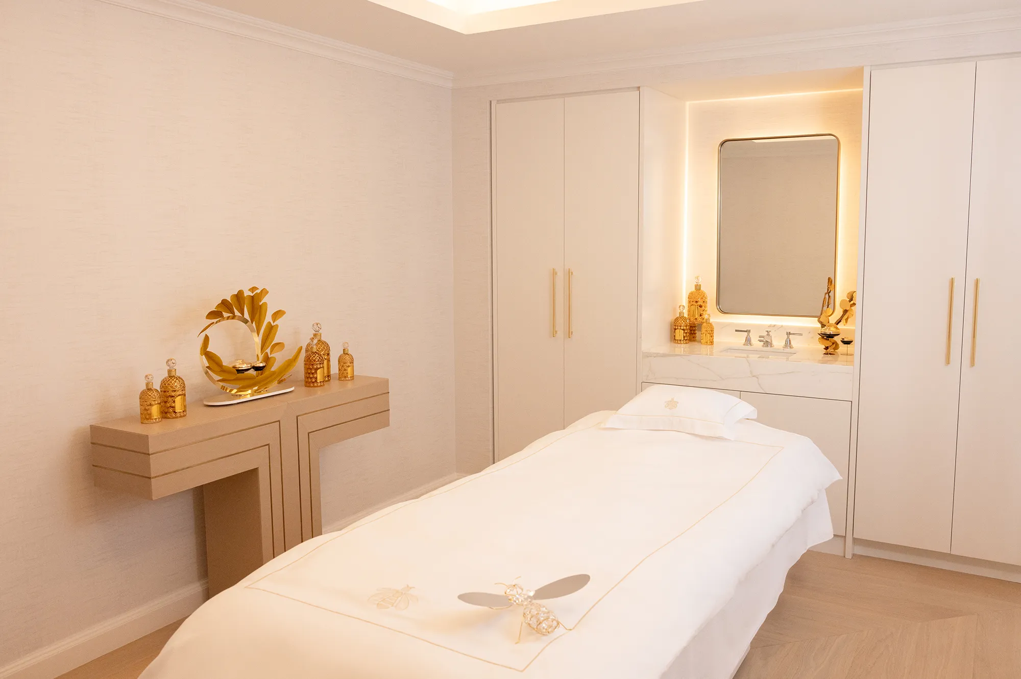 A luxury spa treatment suite at the Waldorf Astoria featuring a massage table and minimalist modern decor.