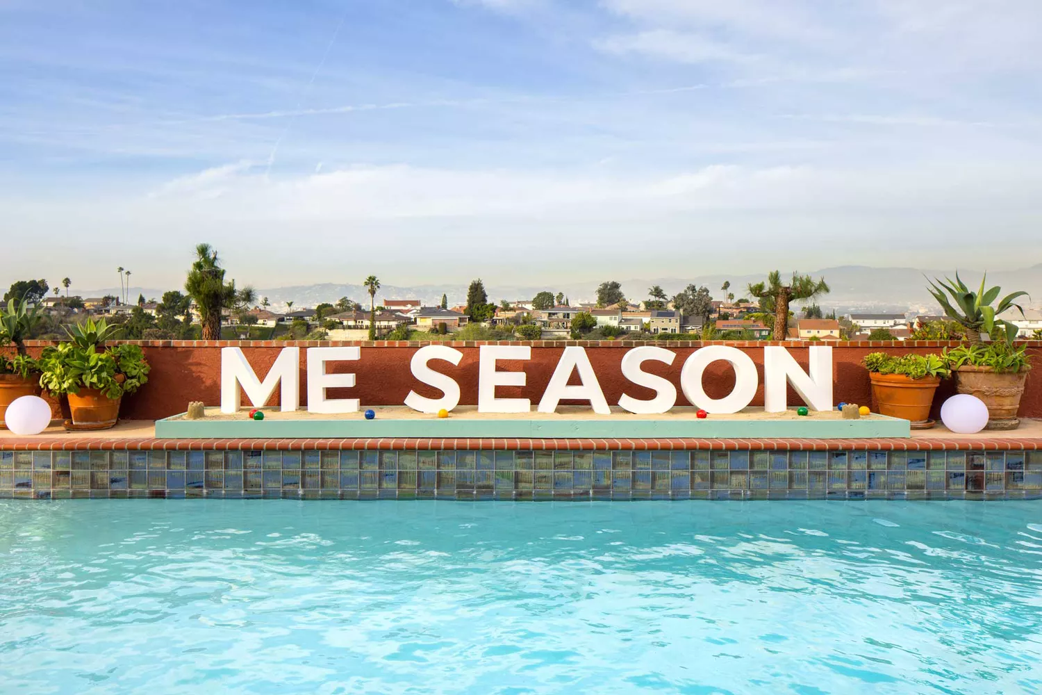 The outdoor pool area and lounge at Issa Rae's Airbnb with vintage-inspired furniture.