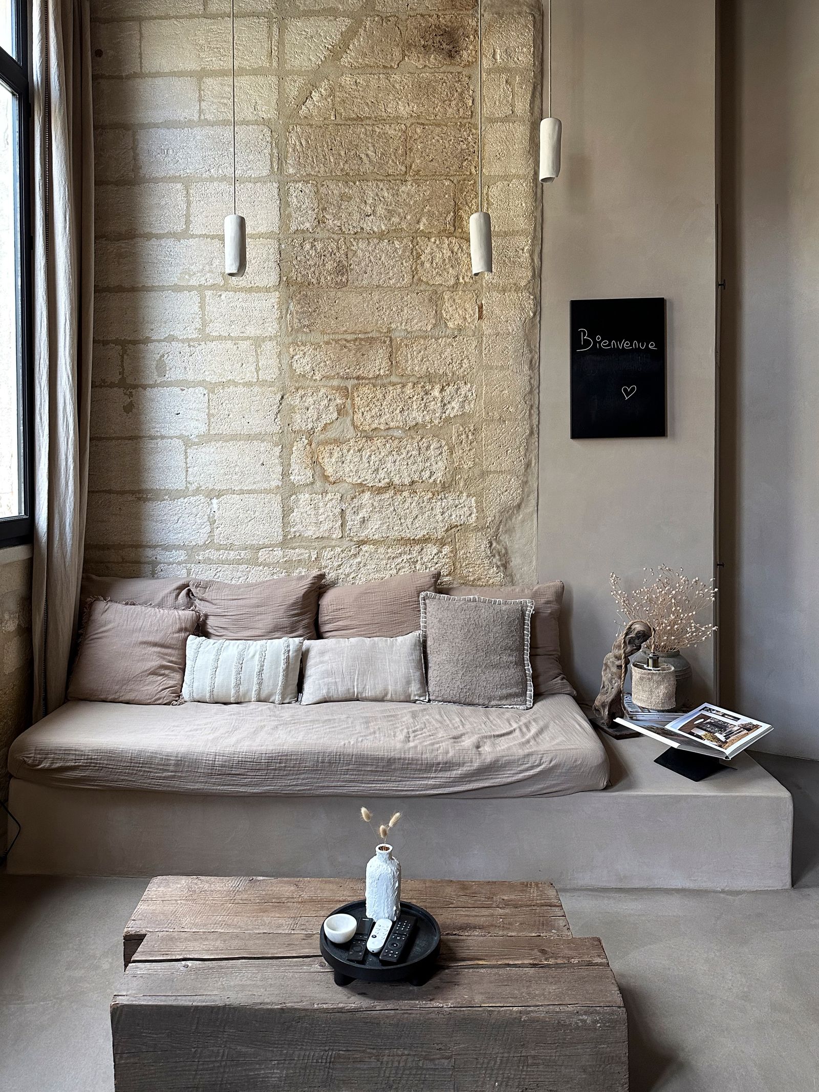 Cozy living room interior with soft cushions and warm home decor in a southern French rental.