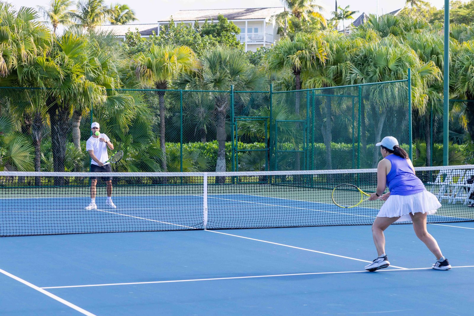 A professional tennis racket and ball placed on a high-quality court surface.
