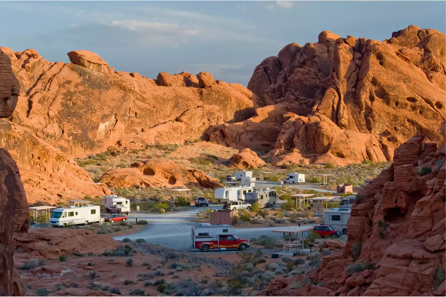 Aerial view of Atlatl Rock Campground in Valley of Fire State Park, showing RV and tent sites nestled against red rock formations.