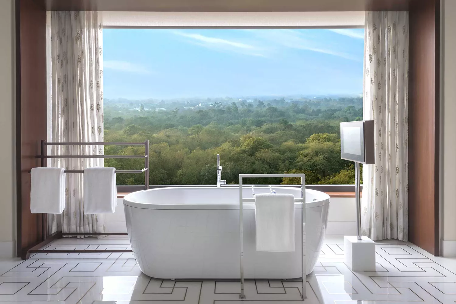 Luxurious bathtub in a suite at The Oberoi, New Delhi, showcasing high-end amenities.