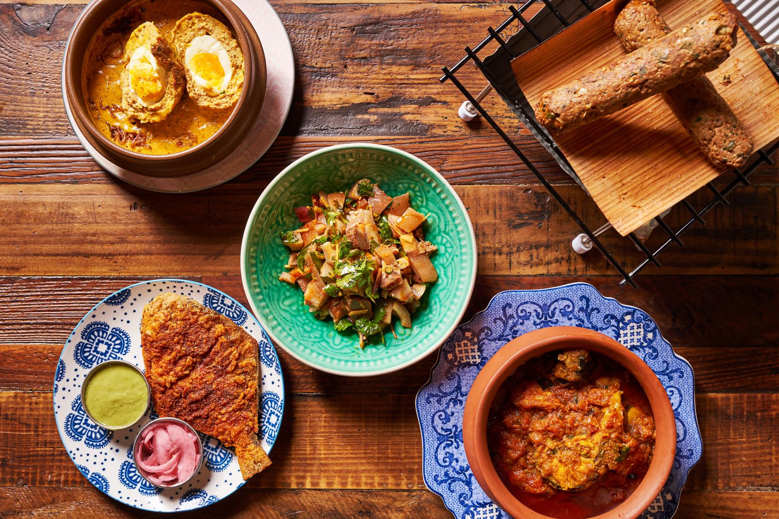 A close-up of a signature dish at Dhamaka restaurant highlighting regional Indian spice and texture.