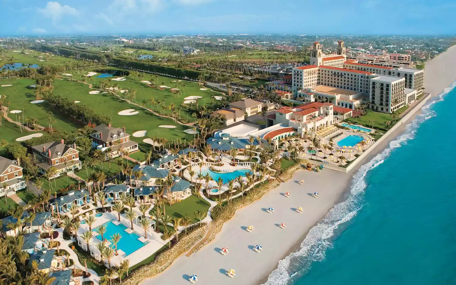 The grand Mediterranean-style facade and manicured lawns of The Breakers Palm Beach.
