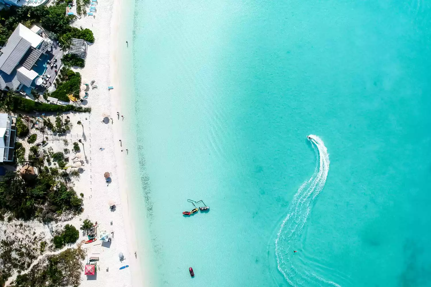 Aerial photo of a white sand beach at Sapodilla Bay in Turks and Caicos.