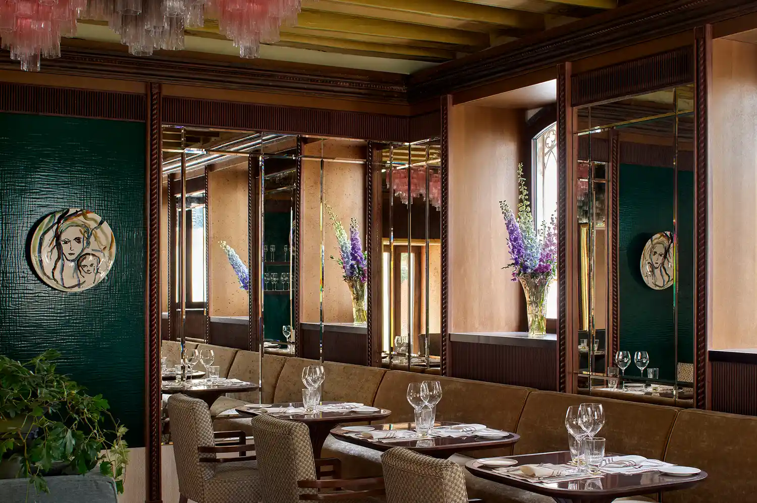 Interior of La Casati restaurant with floral arrangements and elegant wall art.