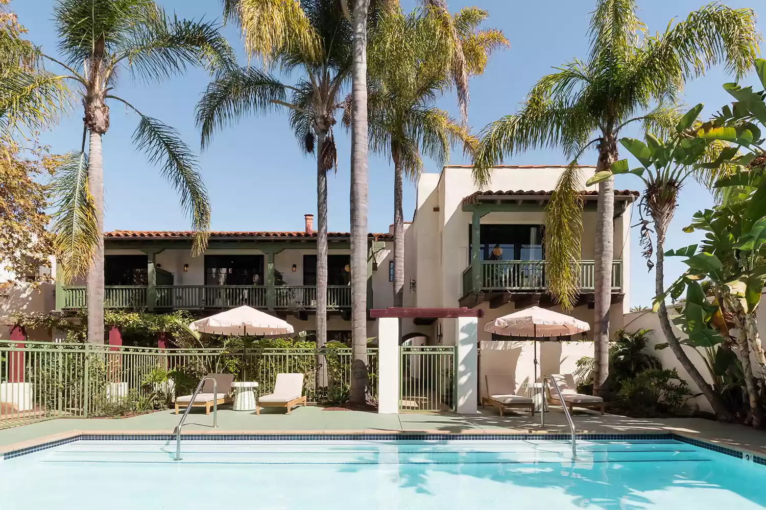 The outdoor swimming pool and historic exterior at Palihouse Santa Barbara.