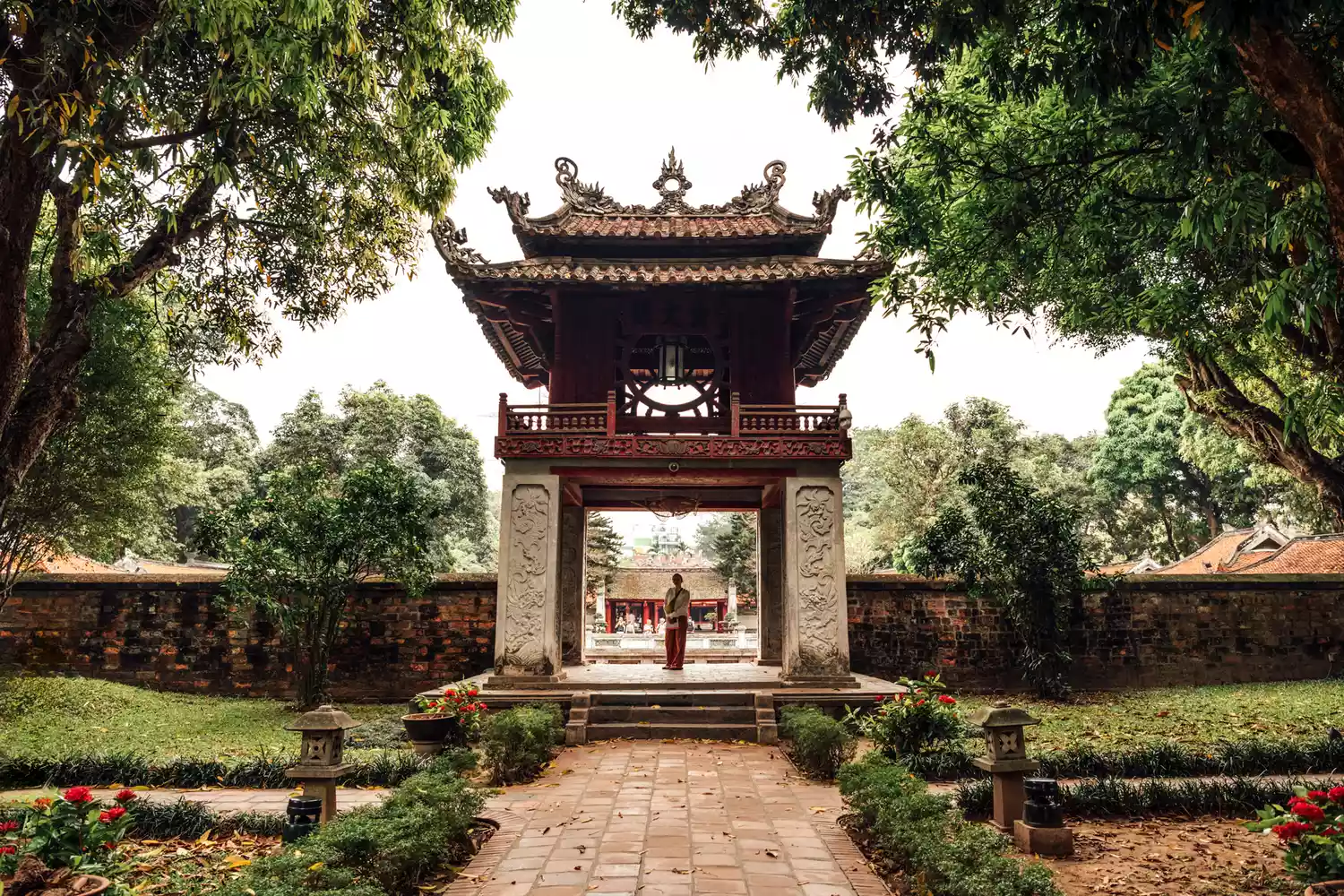 A traditional temple structure in Hanoi surrounded by greenery.