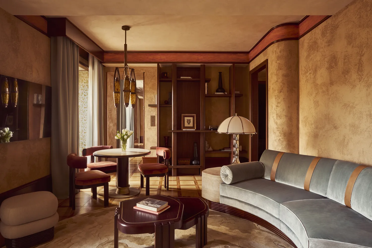 A luxury hotel suite interior at the Orient Express La Minerva in Rome featuring modern furniture and period architectural details.