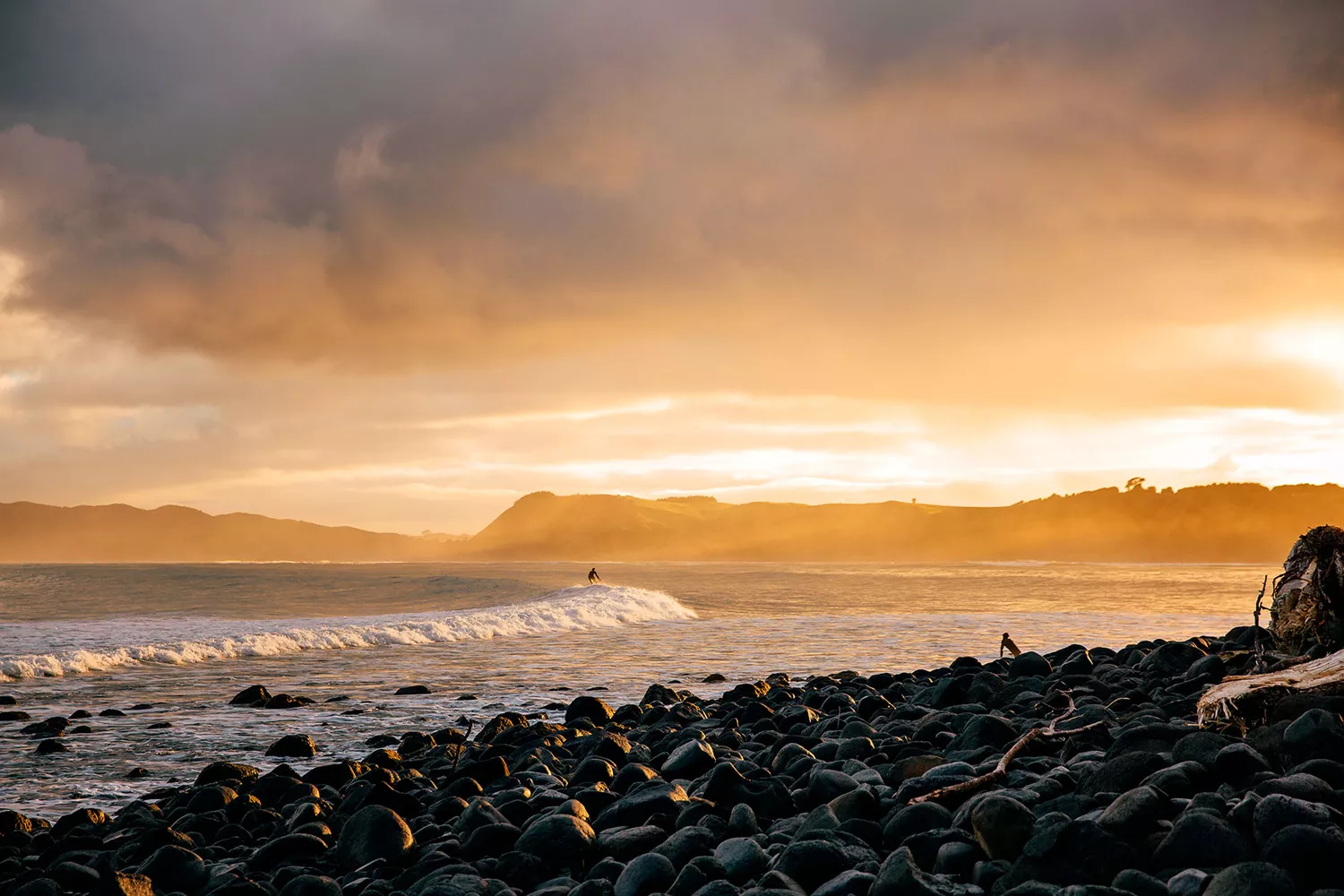 Sunrise light hitting the rolling surf waves at Manu Bay in Raglan.