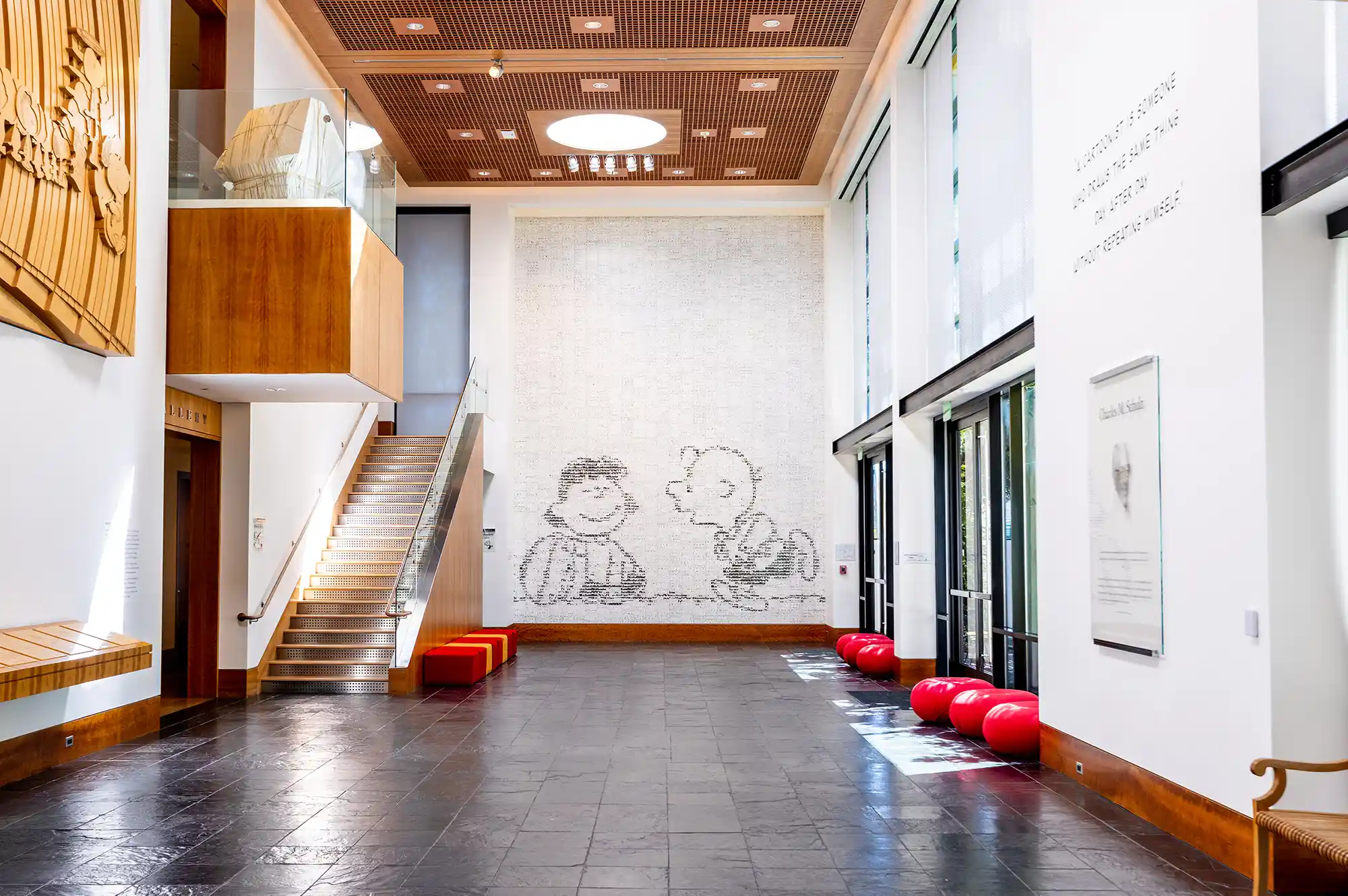 A large interior mural at the Charles M. Schulz Museum featuring various Peanuts characters.