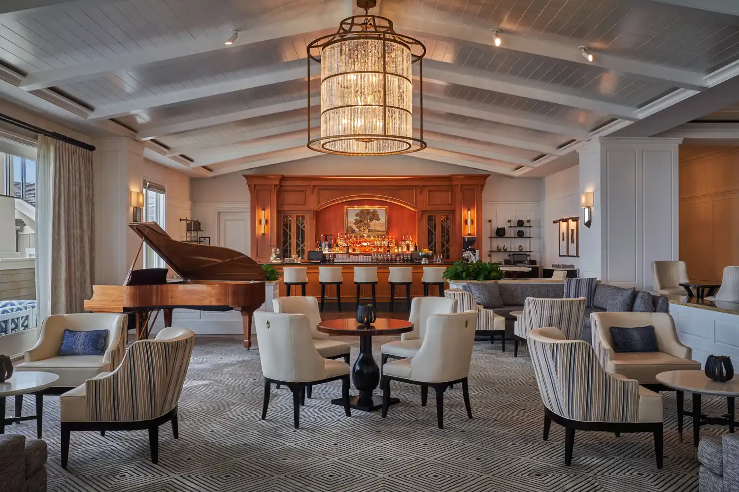The sophisticated lobby bar of the Montage Resort with a grand piano and warm lighting.