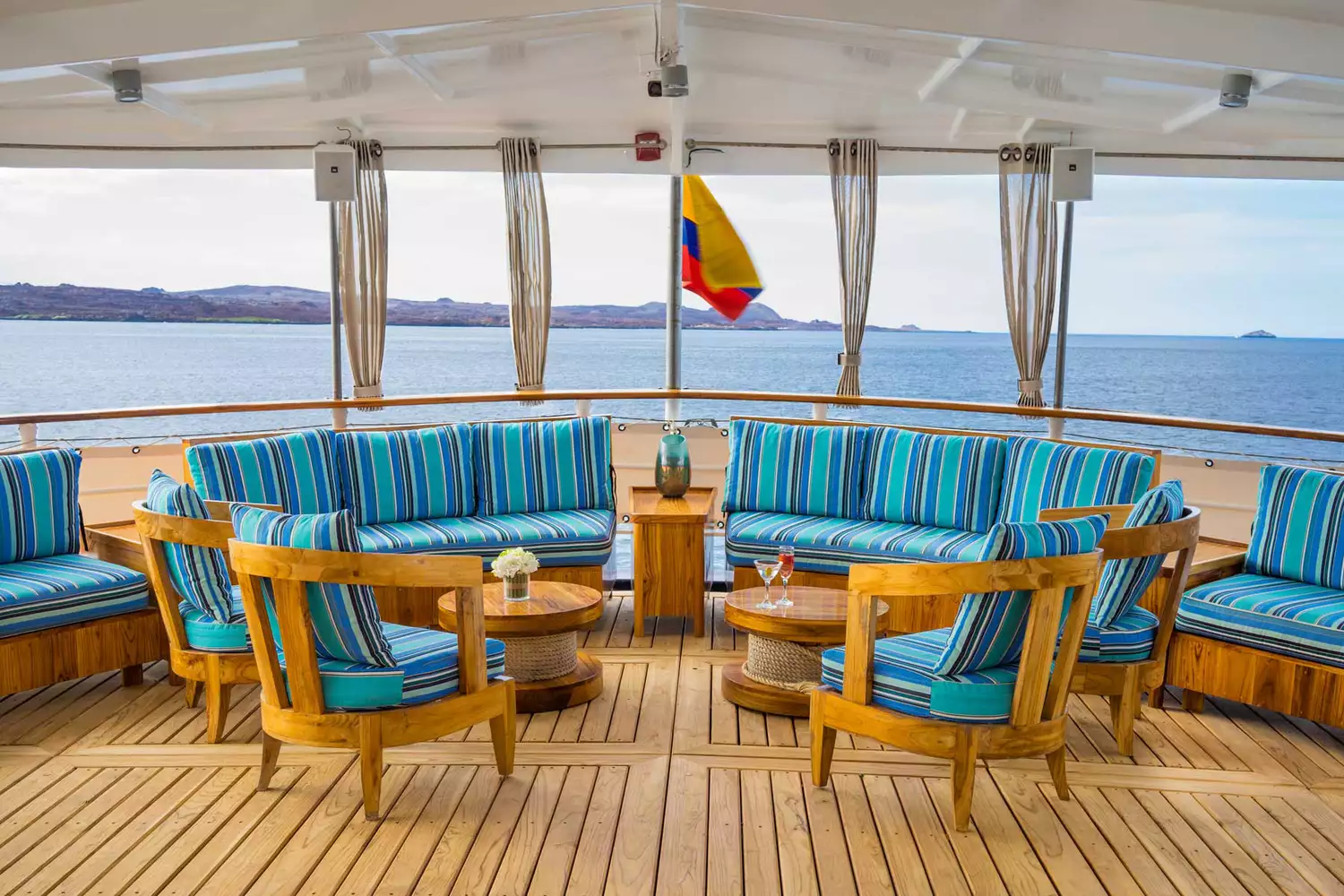 An elegant, well-lit lounge area inside a Quasar Expeditions yacht.